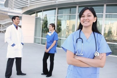 Nurses standing outside a hospital in relation to their DNP program in North Carolina.