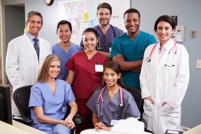 A group of MSN students standing and smiling in an MSN program in Massachusetts.