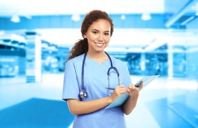 DNP student in Maryland smiling and holding a clipboard.