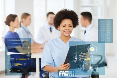 Nurse informatics student analyzing data on a digital interface in a classroom setting in Virginia.